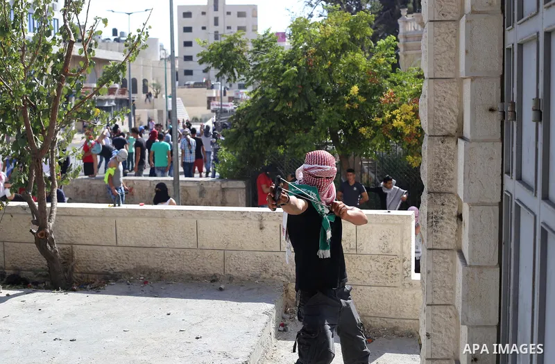 A Palestinian protester hurls stones towards Israeli security forces during clashes at the main entrance of the West Bank city of Bethlehem on October 16, 2015. The unrest that has engulfed Jerusalem and the occupied Wes...