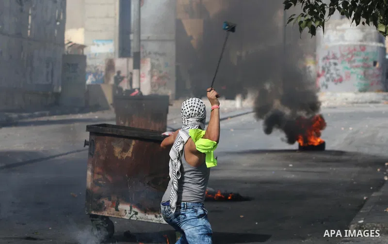 A Palestinian protester hurls stones towards Israeli security forces during clashes at the main entrance of the West Bank city of Bethlehem on October 16, 2015. The unrest that has engulfed Jerusalem and the occupied Wes...