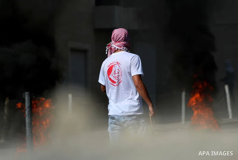 A Palestinian protester looks on during clashes with Israeli security forces at the main entrance of the West Bank city of Bethlehem on October 16, 2015. The unrest that has engulfed Jerusalem and the occupied West Bank,...
