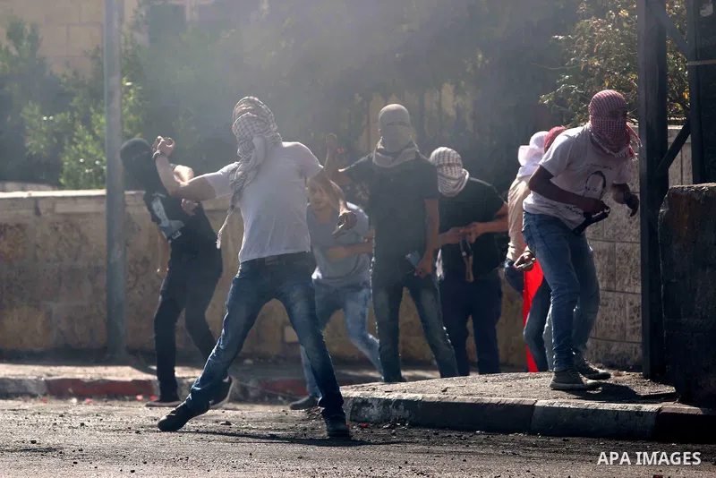 Palestinian protesters throw stones towards Israeli security forces during clashes at the main entrance of the West Bank city of Bethlehem on October 16, 2015. The unrest that has engulfed Jerusalem and the occupied West...