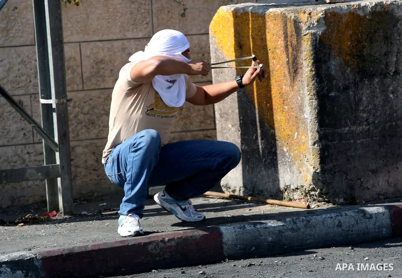 A Palestinian protester hurls stones towards Israeli security forces during clashes at the main entrance of the West Bank city of Bethlehem on October 16, 2015. The unrest that has engulfed Jerusalem and the occupied Wes...