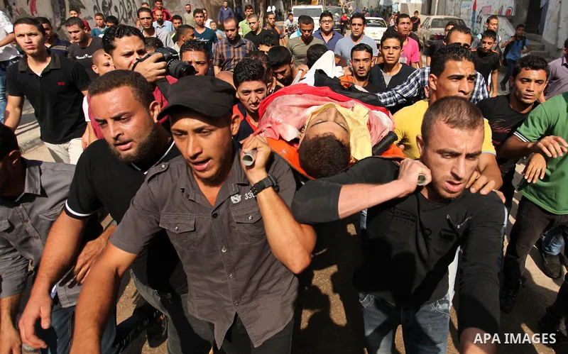Relatives carry the body of Palestinian Mahmoud Hmead, 22, who was killed by Israeli troops in Friday's clashes, during his funeral in Gaza October 17, 2015. The unrest that has engulfed Jerusalem, Gaza and the occupied...