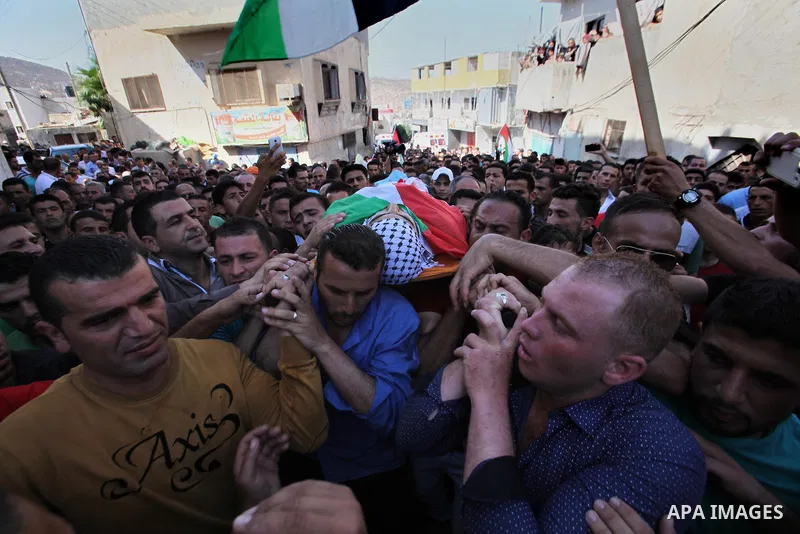Mourners carry the body of Palestinian Ihab Hanani, 19, during his funeral at the Bet Forik village near the West Bank city of Nablus, on October 17, 2015. The unrest that has engulfed Jerusalem, Gaza and the occupied We...