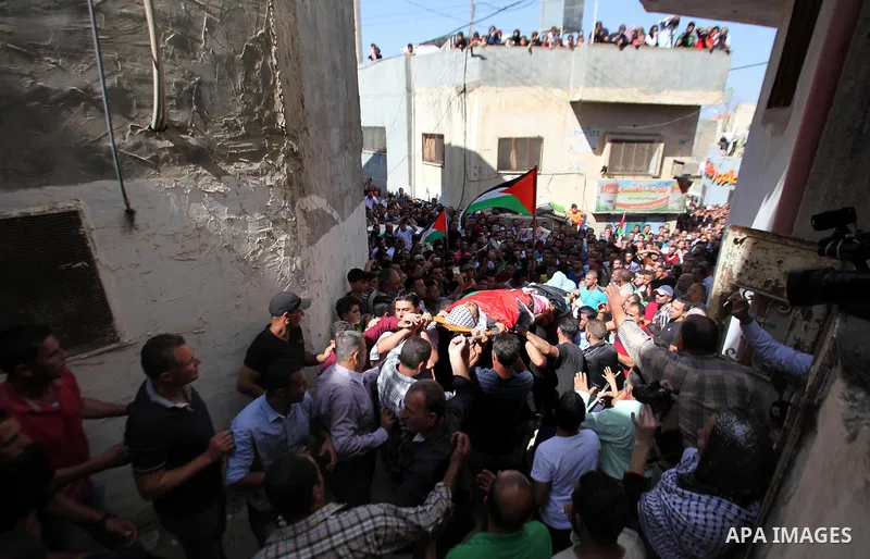 Mourners carry the body of Palestinian Ihab Hanani, 19, during his funeral at the Bet Forik village near the West Bank city of Nablus, on October 17, 2015. The unrest that has engulfed Jerusalem, Gaza and the occupied We...