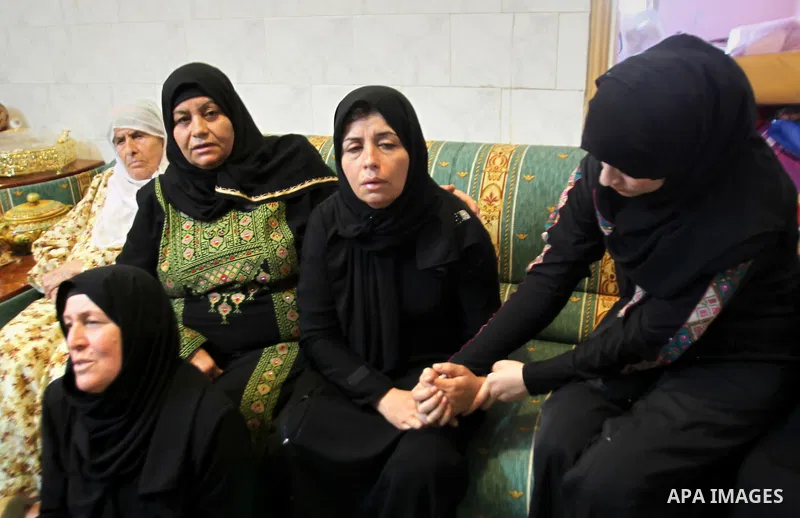 Relatives of Palestinian Ihab Hanani, 19, mourn during his funeral at Beit Furik village near the West Bank city of Nablus, on October 17, 2015. The unrest that has engulfed Jerusalem, Gaza and the occupied West Bank, th...