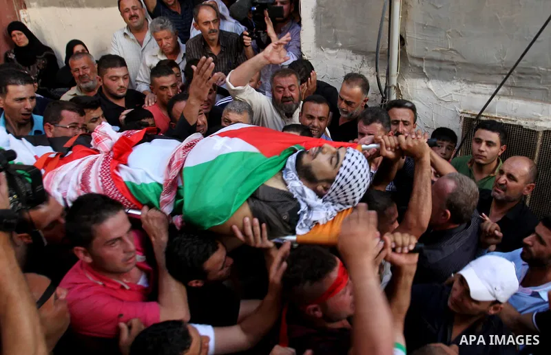 Mourners carry the body of Palestinian Ihab Hanani, 19, during his funeral at the Bet Forik village near the West Bank city of Nablus, on October 17, 2015. The unrest that has engulfed Jerusalem, Gaza and the occupied We...