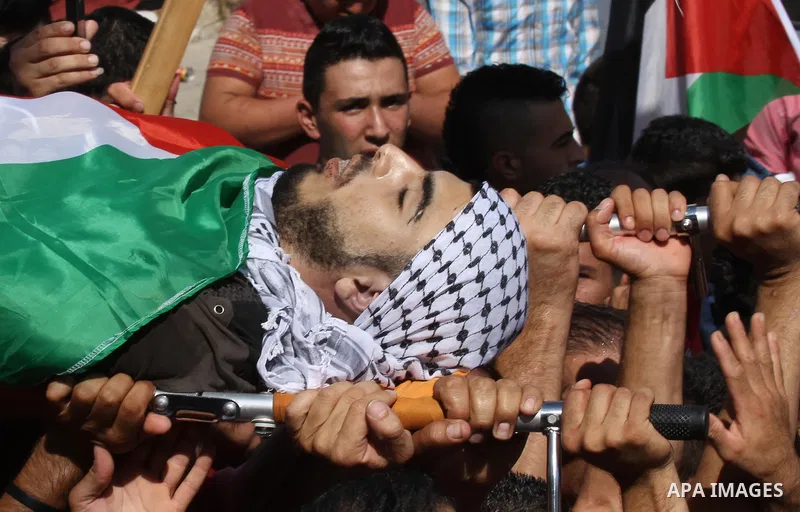 Mourners carry the body of Palestinian Ihab Hanani, 19, during his funeral at the Bet Forik village near the West Bank city of Nablus, on October 17, 2015. The unrest that has engulfed Jerusalem, Gaza and the occupied We...