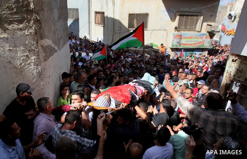 Mourners carry the body of Palestinian Ihab Hanani, 19, during his funeral at the Bet Forik village near the West Bank city of Nablus, on October 17, 2015. The unrest that has engulfed Jerusalem, Gaza and the occupied We...