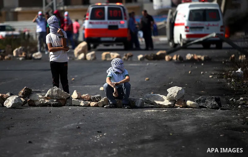 Palestinian protesters take a rest during clashes with Israeli security forces near the Beit El settlement on the outskirts of Ramallah in the West Bank, on October 17, 2015. The unrest that has engulfed Jerusalem and th...
