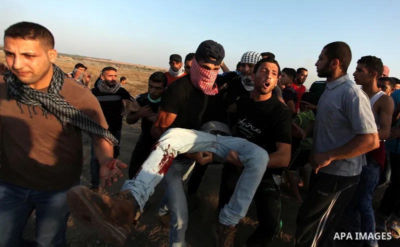A wounded Palestinian protester is evacuated after he was shot by Israeli troops during clashes near the border between Israel and Central Gaza Strip east of Bureij October 17, 2015. At least 40 Palestinians and seven Is...