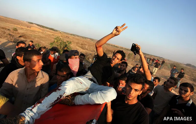 A wounded Palestinian protester is evacuated after he was shot by Israeli troops during clashes near the border between Israel and Central Gaza Strip east of Bureij October 17, 2015. At least 40 Palestinians and seven Is...