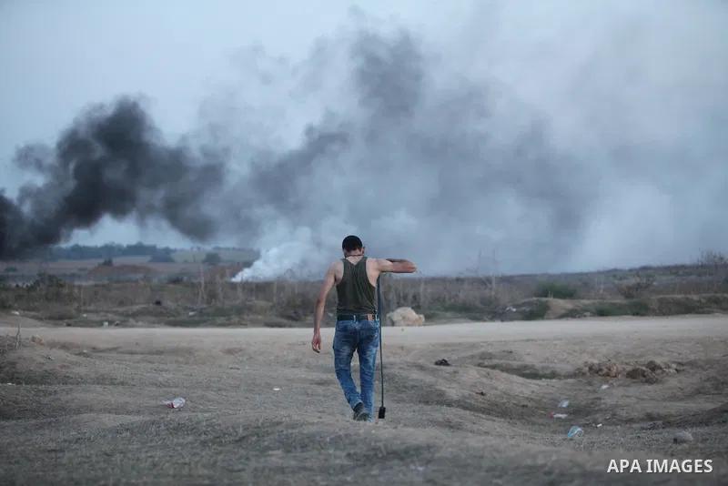 Palestinian protesters hurl stones at Israeli troops during clashes near the border between Israel and Central Gaza Strip east of Bureij on October 17, 2015. At least 40 Palestinians and seven Israelis have died in more...