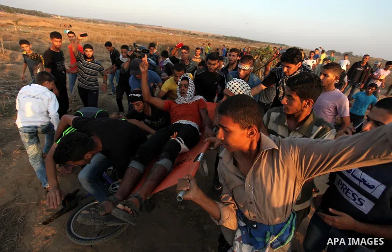 A wounded Palestinian protester is evacuated after he was shot by Israeli troops during clashes near the border between Israel and Central Gaza Strip east of Bureij October 17, 2015. At least 40 Palestinians and seven Is...