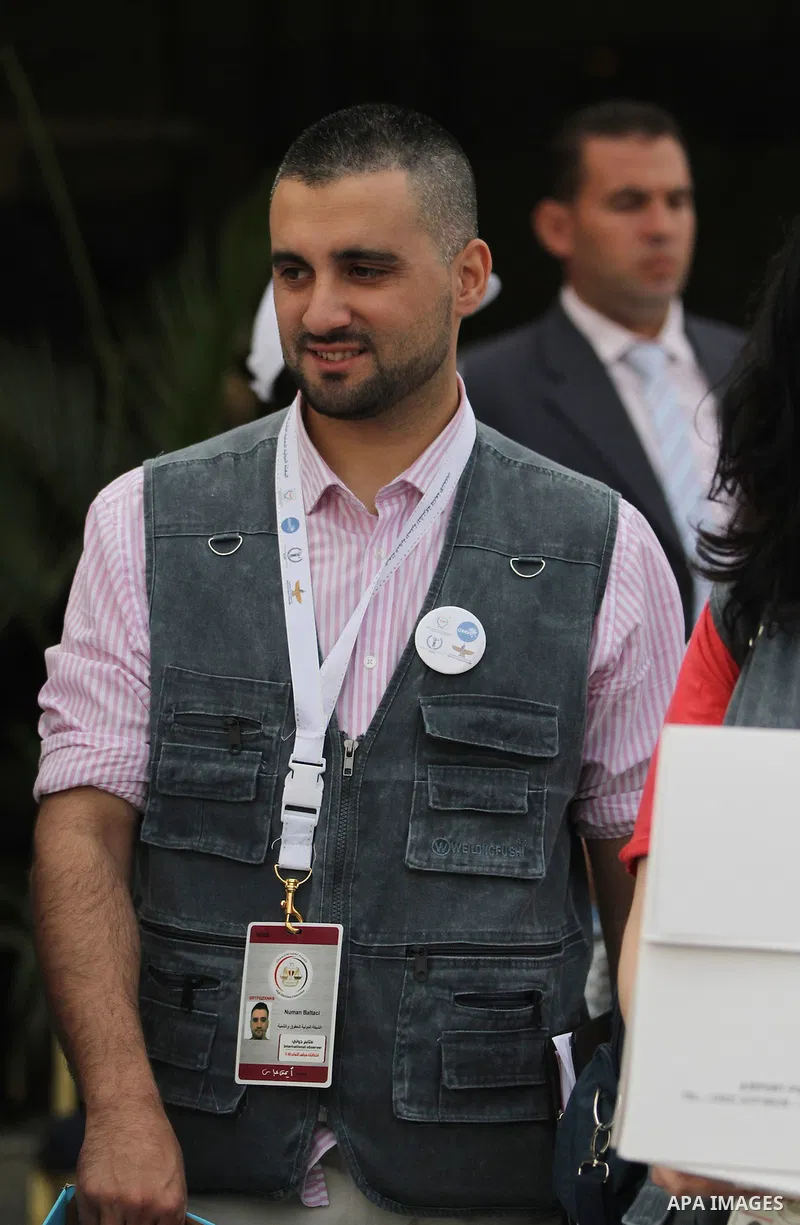 An international observers arrives at the entrance of a polling center, before polls open, during the first round of the parliamentary election in Cairo, Egypt, Sunday, Oct. 18, 2015. Photo by Amr Sayed