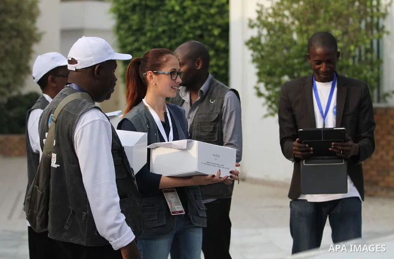 International Observers arrive at the entrance of a polling center, before polls open, during the first round of the parliamentary election in Cairo, Egypt, Sunday, Oct. 18, 2015. Photo by Amr Sayed