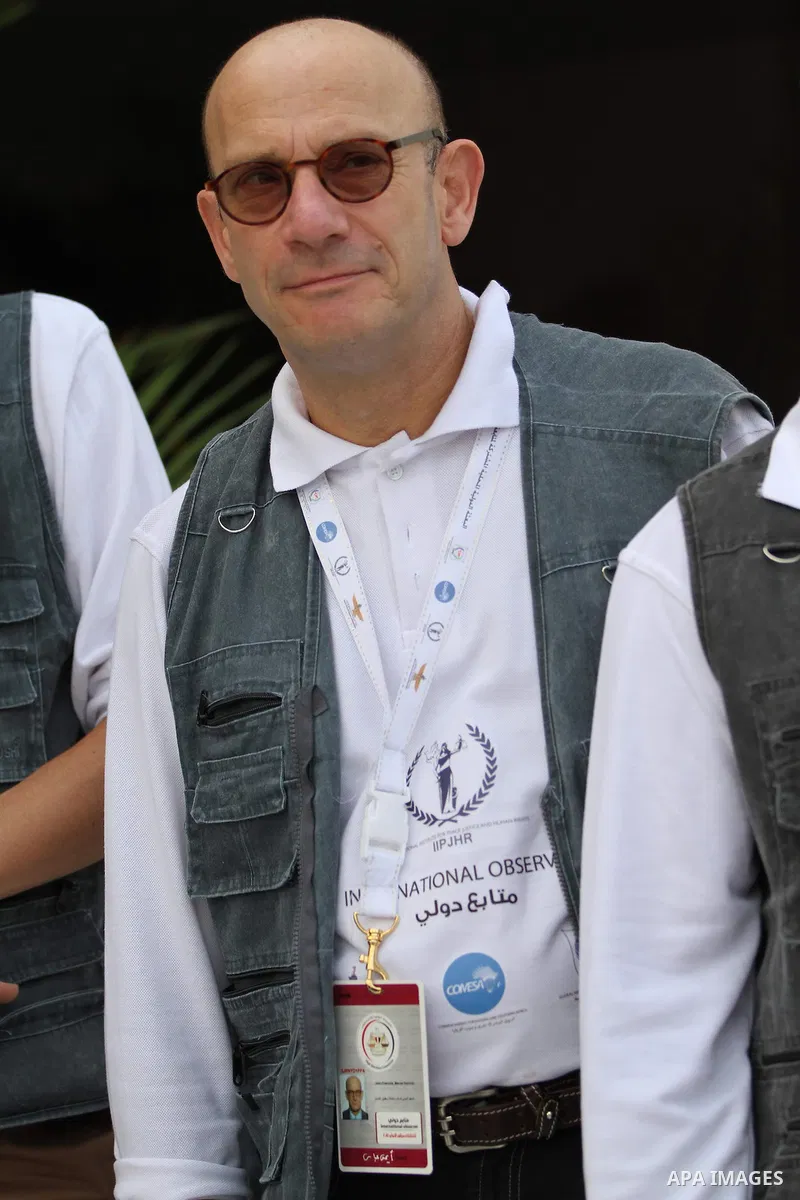 An international observers arrives at the entrance of a polling center, before polls open, during the first round of the parliamentary election in Cairo, Egypt, Sunday, Oct. 18, 2015. Photo by Amr Sayed