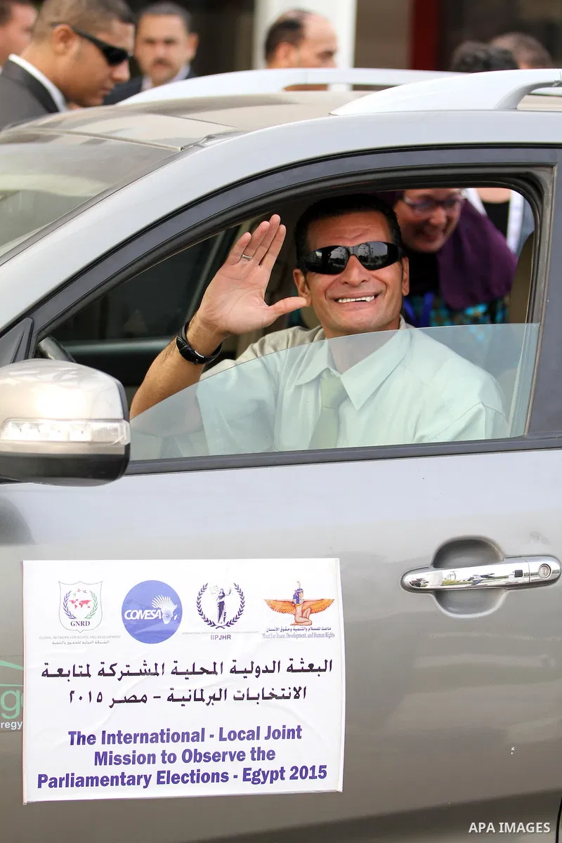 An international observers arrives at the entrance of a polling center, before polls open, during the first round of the parliamentary election in Cairo, Egypt, Sunday, Oct. 18, 2015. Photo by Amr Sayed