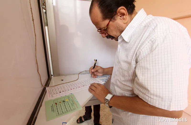 An Egyptian man casts his ballot in the Egyptian parliamentary elections at a polling station in the Al-Ayyat area of Giza, 40kms (25 miles) southwest of Cairo, on October 18, 2015. Polling opened earlier in the day in E...