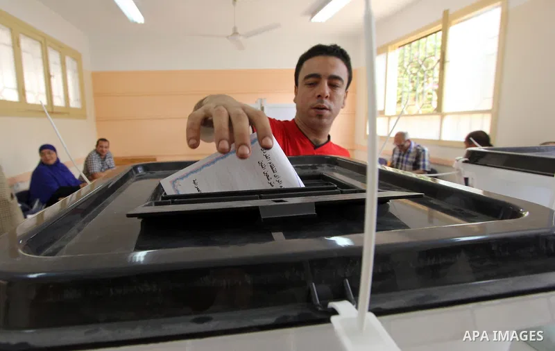 An Egyptian man casts his ballot in the Egyptian parliamentary elections at a polling station in the Al-Ayyat area of Giza, 40kms (25 miles) southwest of Cairo, on October 18, 2015. Polling opened earlier in the day in E...