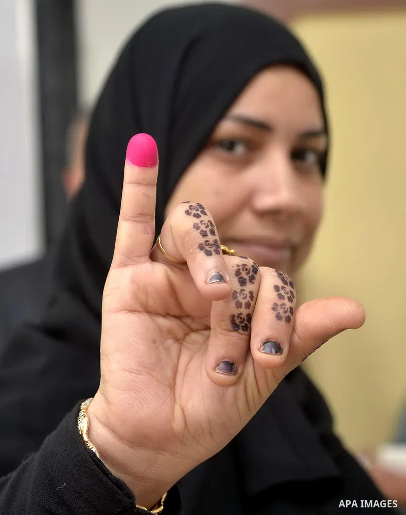 Egyptians participate in the election voting at a polling station in Giza governorate, Egypt, October 18, 2015. Egypt's long-awaited parliamentary election got off to a slow start on Sunday, marking the final step in a p...