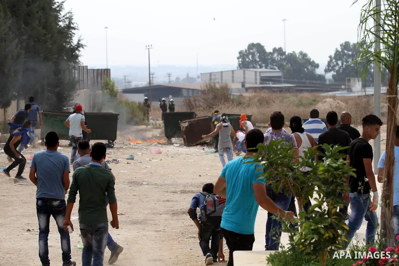 Palestinian protesters throw stones towards Israeli security forces during clashes in the West Bank town of Tulkarm, October 18, 2015. Tensions in the region run high after weeks of street violence with the unrest being...
