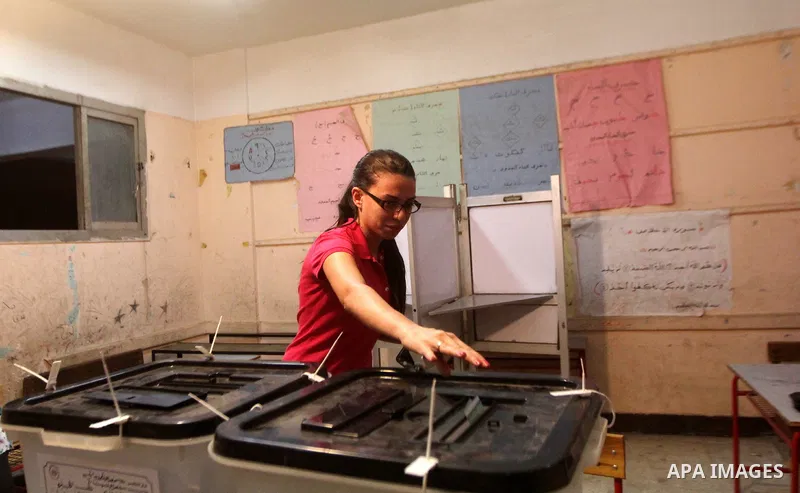 An Egyptian woman casts her ballot in the Egyptian parliamentary elections at a polling station in Cairo, on October 18, 2015. Polling opened earlier in the day in Egypt to elect a new parliament that will tighten Presid...