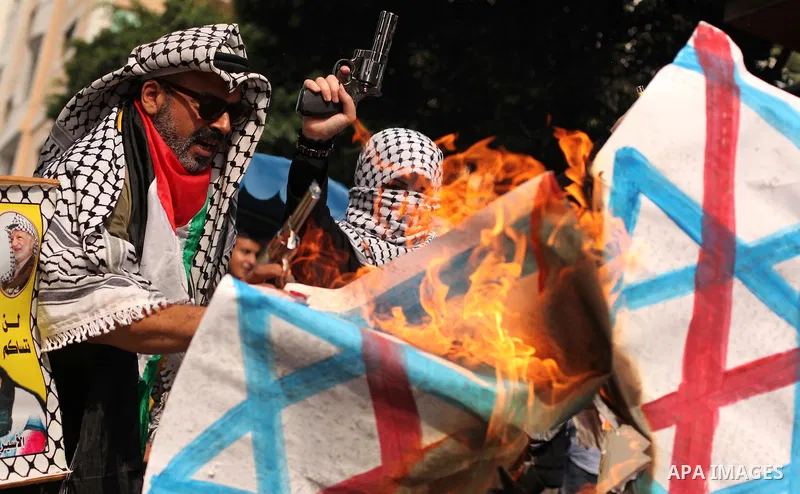 Palestinians burn an Israeli flag during in an anti-Israel protest in front of Red cross office, in Gaza city, on Oct. 19, 2015. Israel pressed ahead with major security measures after five more stabbing incidents, while...