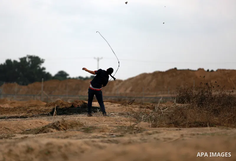 Palestinian protesters clash with Israeli troops near the border between Israel and Central Gaza Strip October 19, 2015. More than two weeks of unrest have raised warnings of the risk of a full-scale Palestinian uprising...