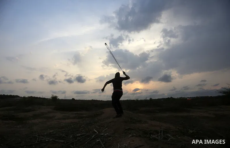 Palestinian protesters clash with Israeli troops near the border between Israel and Central Gaza Strip October 19, 2015. More than two weeks of unrest have raised warnings of the risk of a full-scale Palestinian uprising...