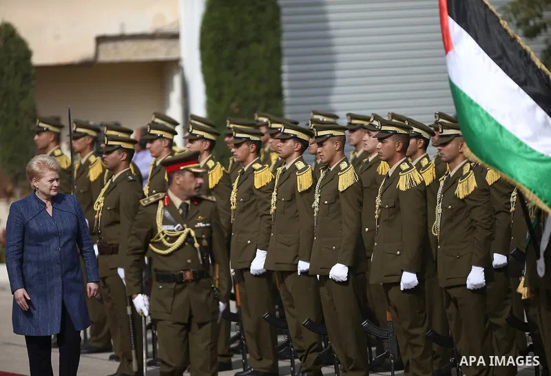 Palestinian president Mahmoud Abbas, left, reviews an honor guard with The Republic of Lithuania president, Dalia Grybauskaite, upon her arrival to the West Bank city of Ramallah on October 20, 2015. Photo by Fadi Arouri...