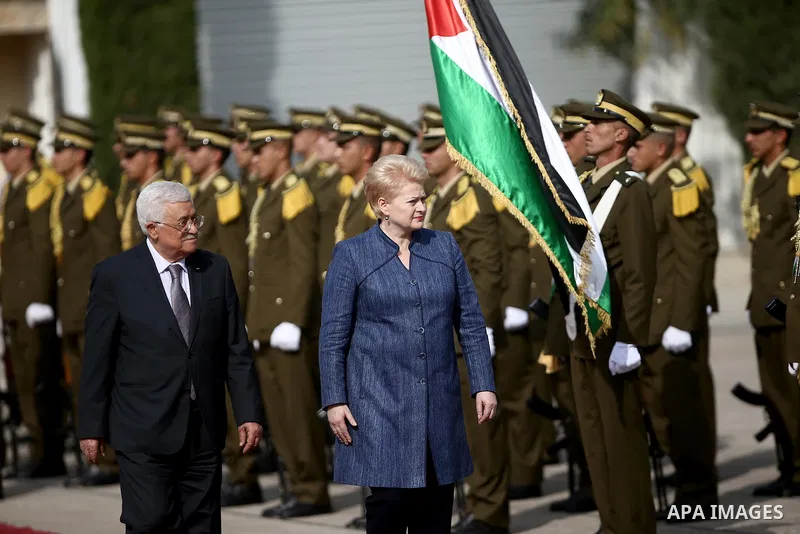 Palestinian president Mahmoud Abbas, left, reviews an honor guard with The Republic of Lithuania president, Dalia Grybauskaite, upon her arrival to the West Bank city of Ramallah on October 20, 2015. Photo by Fadi Arouri...
