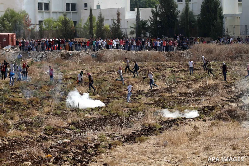 Palestinian protesters throw stones at Israeli security forces during clashes in the West Bank town of Tulkarm, October 20, 2015. Triggered by Israeli incursions into the Al-Aqsa Mosque compound last month, violence and...