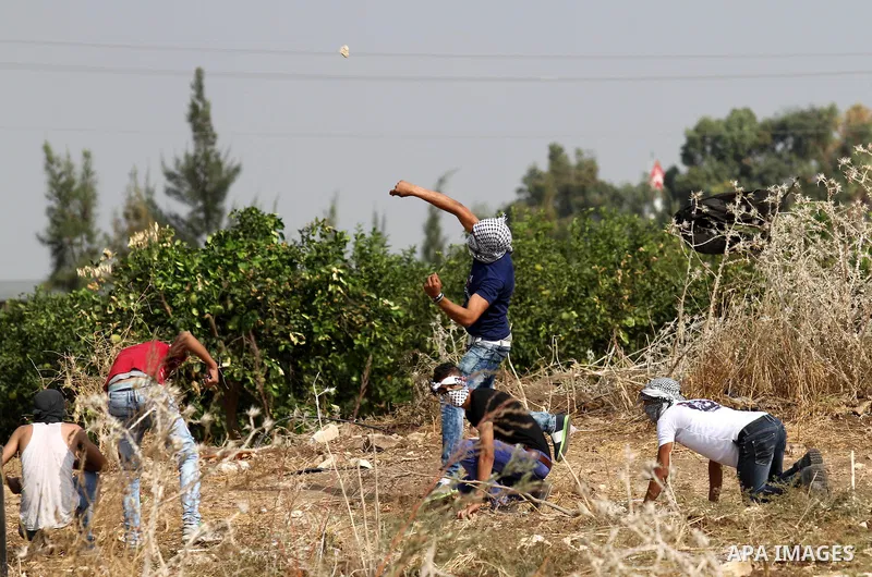 Palestinian protesters throw stones at Israeli security forces during clashes in the West Bank town of Tulkarm, October 20, 2015. Triggered by Israeli incursions into the Al-Aqsa Mosque compound last month, violence and...