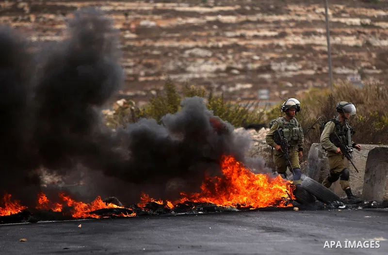 Israeli security forces take postion during clashes with Palestinian protesters near the Jewish settlement of Beit El, near Ramallah on October 23, 2015. Palestinian factions called for mass rallies against Israel in the...