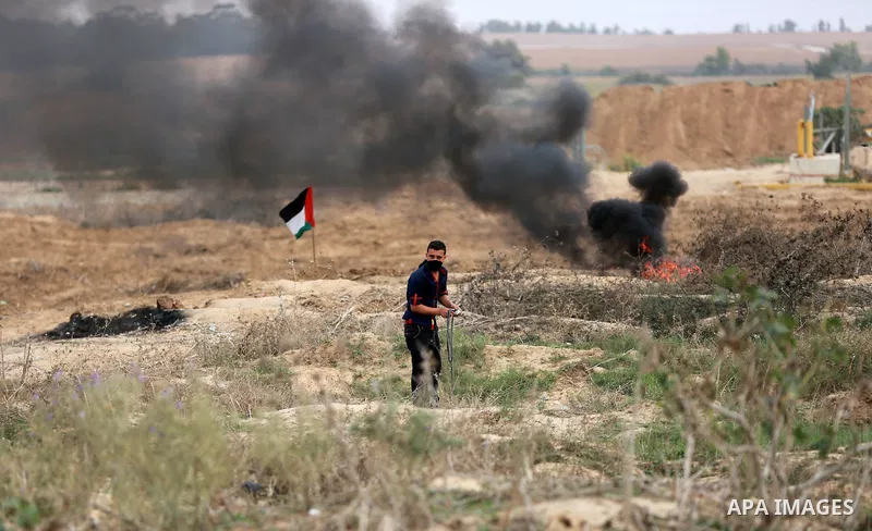 Palestinian protesters participate in clashes with Israeli security forces near the border between Israeli and central Gaza Stirp, on October 23, 2015. Palestinian factions called for mass rallies against Israel in the o...