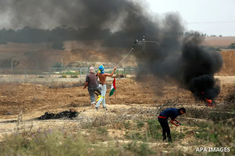 Palestinian protesters participate in clashes with Israeli security forces near the border between Israeli and central Gaza Stirp, on October 23, 2015. Palestinian factions called for mass rallies against Israel in the o...