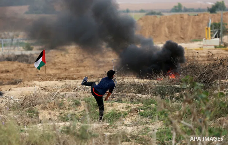 Palestinian protesters participate in clashes with Israeli security forces near the border between Israeli and central Gaza Stirp, on October 23, 2015. Palestinian factions called for mass rallies against Israel in the o...
