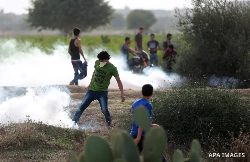 Palestinian protesters participate in clashes with Israeli security forces near the border between Israeli and central Gaza Stirp, on October 23, 2015. Palestinian factions called for mass rallies against Israel in the o...
