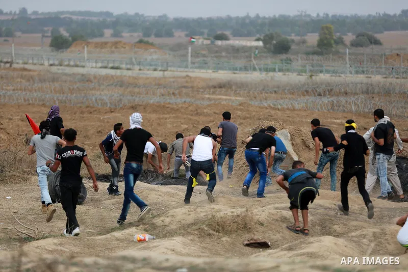Palestinian protesters participate in clashes with Israeli security forces near the border between Israeli and central Gaza Stirp, on October 23, 2015. Palestinian factions called for mass rallies against Israel in the o...