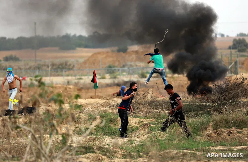Palestinian protesters participate in clashes with Israeli security forces near the border between Israeli and central Gaza Stirp, on October 23, 2015. Palestinian factions called for mass rallies against Israel in the o...