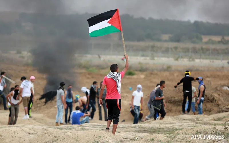 Palestinian protesters participate in clashes with Israeli security forces near the border between Israeli and central Gaza Stirp, on October 23, 2015. Palestinian factions called for mass rallies against Israel in the o...