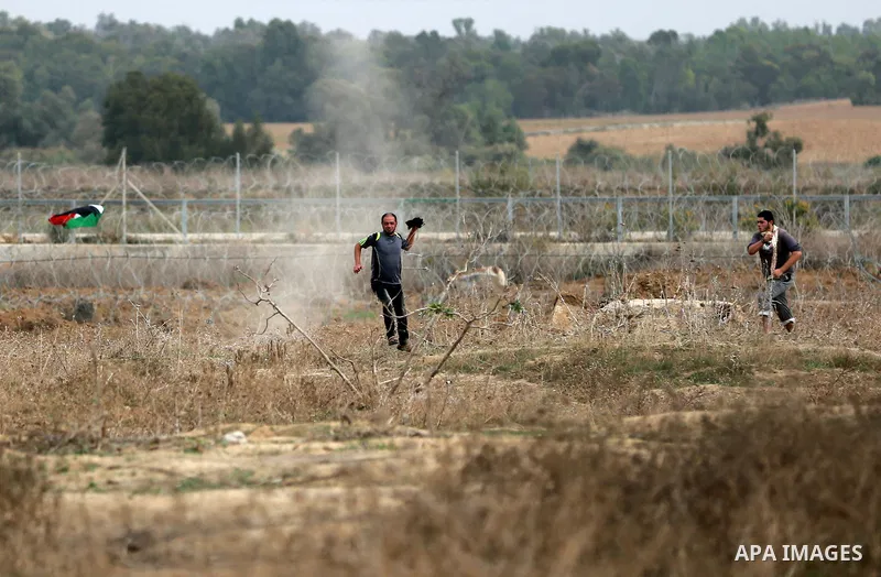 Palestinian protesters participate in clashes with Israeli security forces near the border between Israeli and central Gaza Stirp, on October 23, 2015. Palestinian factions called for mass rallies against Israel in the o...