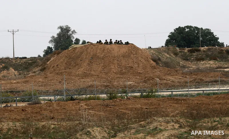 Israeli security forces take position during clashes with Palestinian protesters near the border between Israeli and central Gaza Strip, on October 23, 2015. Palestinian factions called for mass rallies against Israel in...