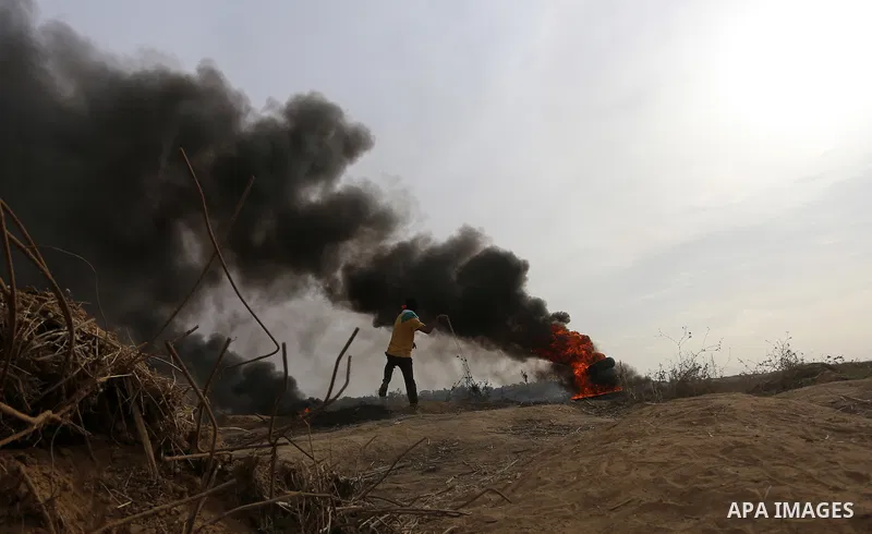 A Palestinian protester uses a sling shot to throw stones during clashes with Israeli security forces near the border between Israeli and central Gaza Strip, on October 23, 2015. Palestinian factions called for mass rall...