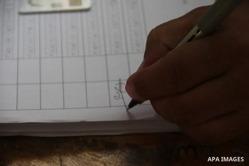 An Egyptian casts his ballot at a polling station in Cairo, as voters returned to polling stations on October 27, 2015 for a first round run-off in a parliamentary vote expected to elect lawmakers firmly backing Presiden...
