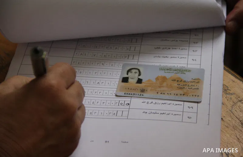An Egyptian casts his ballot at a polling station in Cairo, as voters returned to polling stations on October 27, 2015 for a first round run-off in a parliamentary vote expected to elect lawmakers firmly backing Presiden...