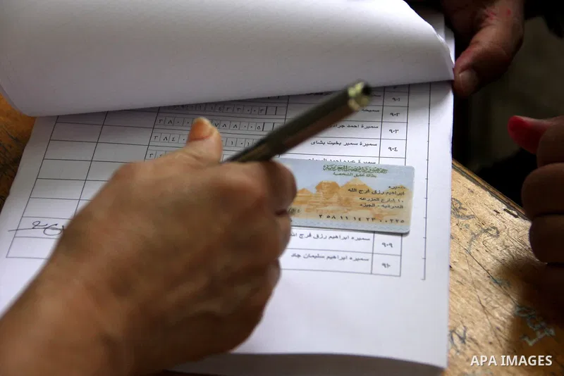 An Egyptian casts his ballot at a polling station in Cairo, as voters returned to polling stations on October 27, 2015 for a first round run-off in a parliamentary vote expected to elect lawmakers firmly backing Presiden...
