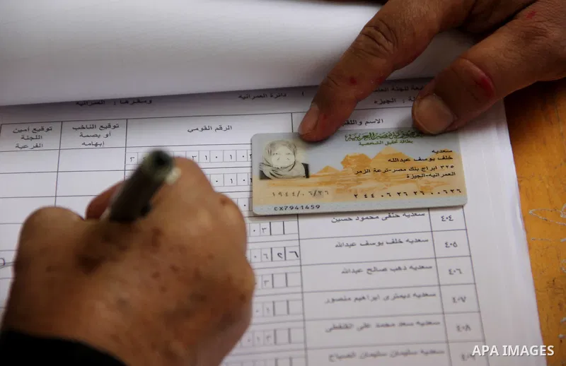 An Egyptian casts his ballot at a polling station in Cairo, as voters returned to polling stations on October 27, 2015 for a first round run-off in a parliamentary vote expected to elect lawmakers firmly backing Presiden...