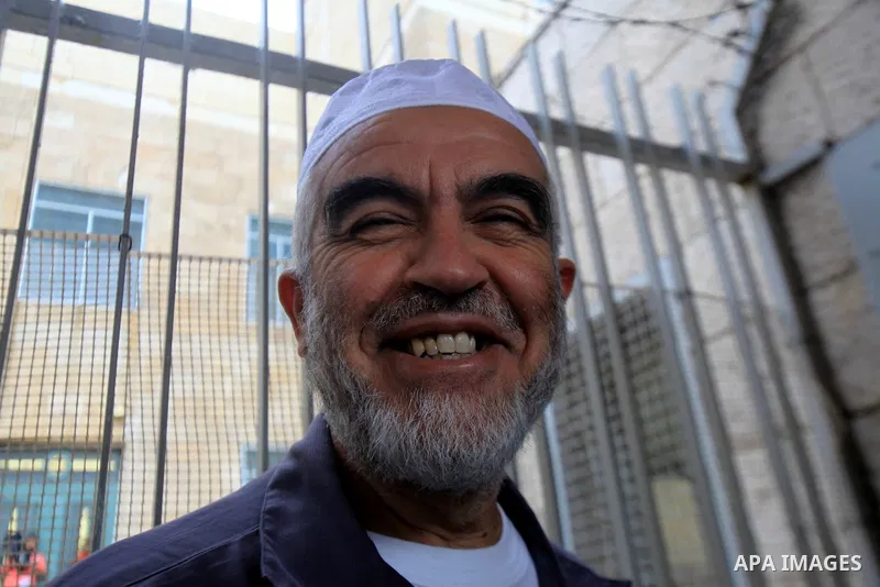 Leader of the radical northern wing of the Islamic Movement in Israel, Sheikh Raed Salah, poses for a photograph outside a Jerusalem court after he was convicted on October 27, 2015. An Israeli court upheld a conviction...
