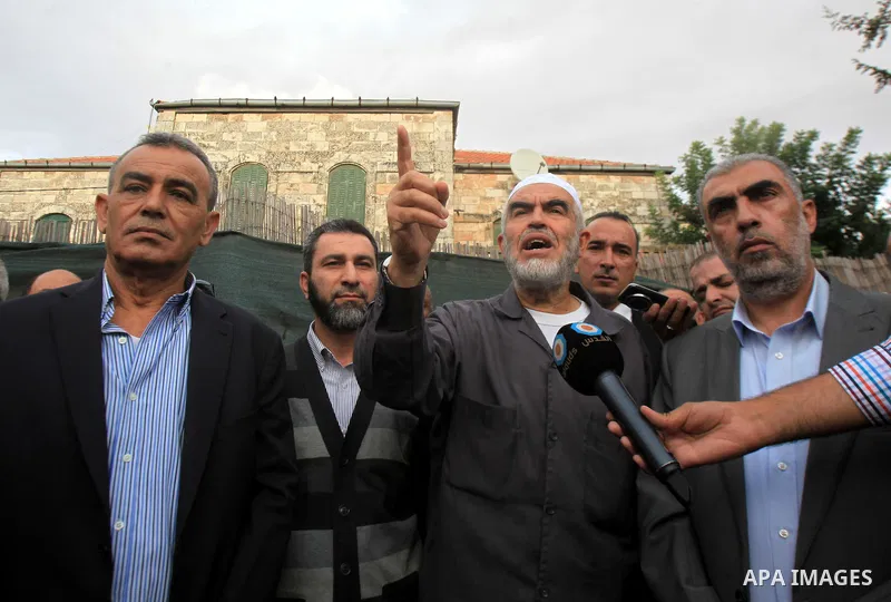 Leader of the radical northern wing of the Islamic Movement in Israel, Sheikh Raed Salah, speaks to media outside a Jerusalem court after he was convicted on October 27, 2015. An Israeli court upheld a conviction of the...